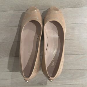 Stuart Weitzman patent leather nude peep toe pumps